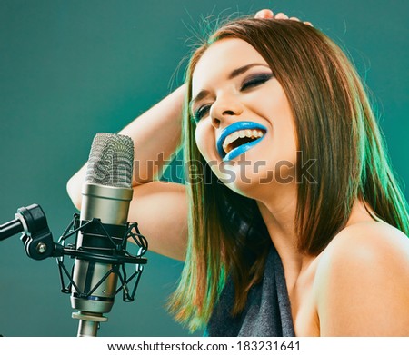 Young woman sing with microphone.
