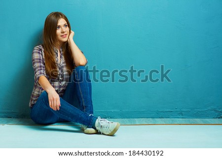 Fashion girl portrait in casual country style. Blue wall.