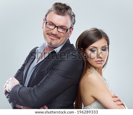 Funny couple portrait. Man and woman standing against gray. Isolated.