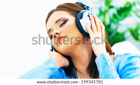 Music woman. Girl listening music with headphones. Home portrait.