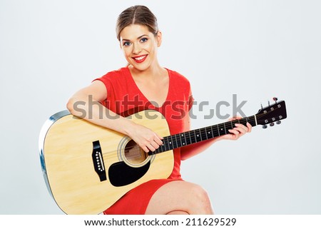 young woman play music . isolated portrait of female model with guitar .