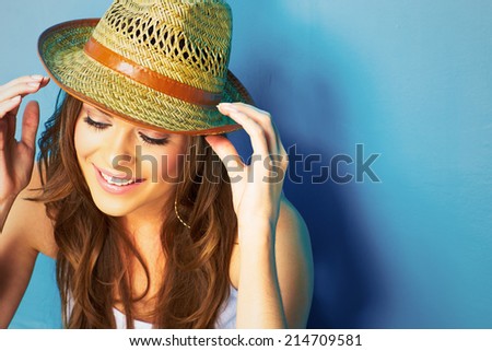 Beautiful modern style woman looking down . face portrait . yellow hat .