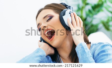 Singing woman portrait with headphones.
