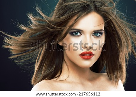 Young beauty model with blowing hair. Studio isolated portrait.