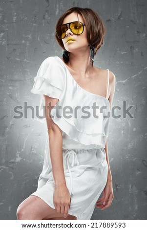 Fashion photo of young model. White cocktail dress.