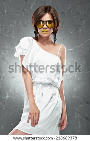 Fashion photo of young model. White cocktail dress.
