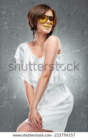 Sexy Fashion model portrait on vintage grunge background. White dress.