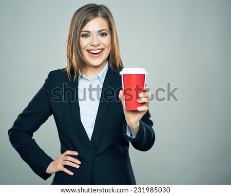 Business woman dressed office style suit smiling and hold red cup of hot drink. Isolated business portrait.