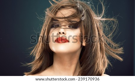 Portrait of beautiful smiling woman with long blowing hair. Hair style portrait.