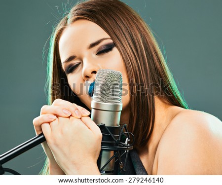 Close up beautiful woman singer portrait. Sound studio.