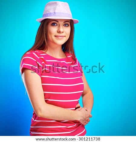 Young smiling woman standing against blue background. isolated studio portrait.