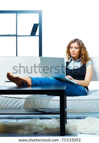 Young woman student relaxing with  laptop on a couch