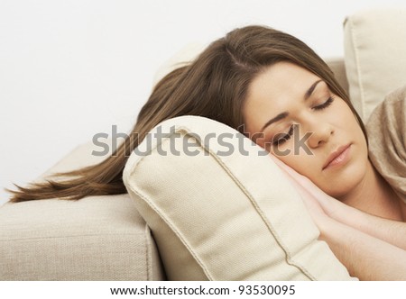 Young sleeping woman closeup portrait. Indoor girl relaxed