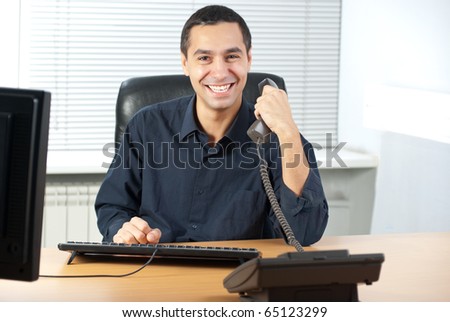 Young caucasian businessman talking on cell telephone and