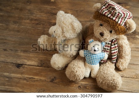 Three toy bears. Symbolize a family: mother, father and son. On a textural background