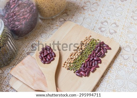 red beans on wood ladle,and red beans soybeans green beans on chopping block