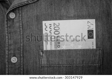 black and white euro bank note in jeans shirt pocket