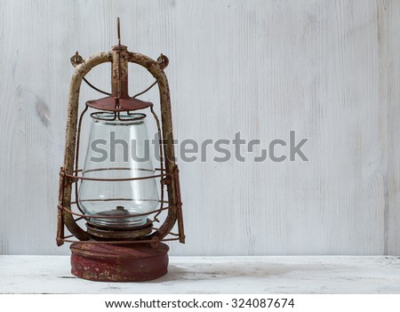 old oil lamp on white wooden table