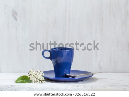 blue mugs and forks on white table