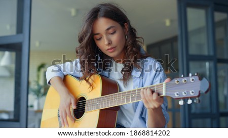 Similar – Image, Stock Photo Positive woman playing guitar in bedroom