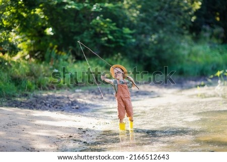Similar – Image, Stock Photo Children playing with fishing rod toy in a pool in a home garden