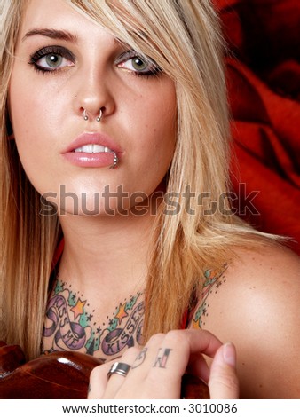 Beautiful blonde model with tattoos in studio