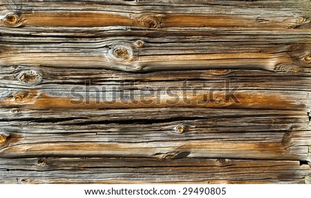 a weathered wooden log texture of an old rustic timber house