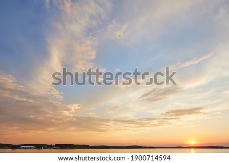 Similar – Foto Bild rosa blaue Abendstimmung am Strand am Meer mit geschlossenem Sonnenschirm und Lichtgirlande