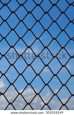 The metallic fence and a blue sky with white clouds