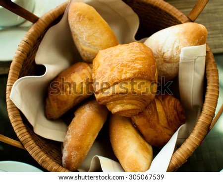 different breakfast buns in basket top view
