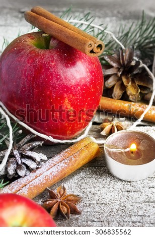 Christmas composition: Apple, candle and cinnamon sticks