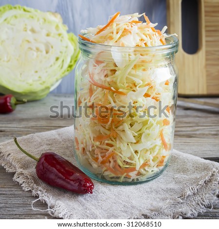 Pickled cabbage with carrots and red hot peppers, selective focu