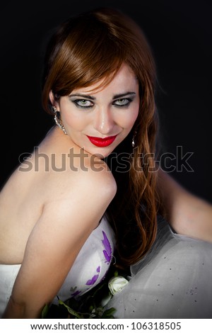 Picture of a beautiful woman with red hair wearing beautiful jewelry over black background