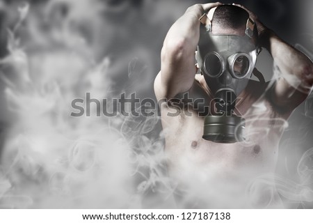 Portrait of a man in a polluted ambience with gas mask