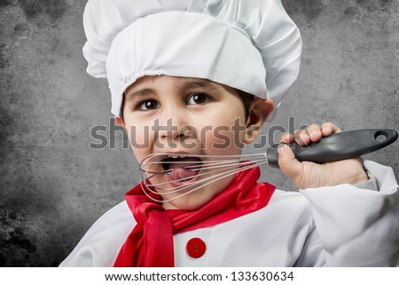 A little boy cook in uniform over vintage  background