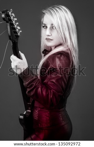 young beautiful blonde with red light, electric guitar