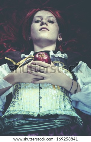 Young drown woman in a poetic representation. Holding an apple, fantasy art
