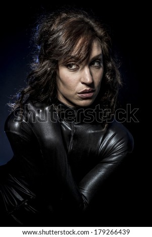 Sexy brunette in black latex costume, Fashion shot of a woman in black glossy