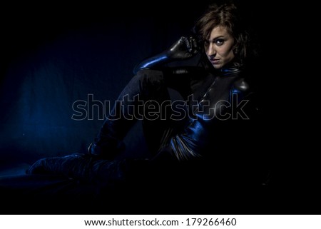Sexy brunette in black latex costume, Fashion shot of a woman in black glossy