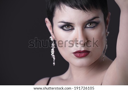 Sensual brunette with beautiful green eyes and silver jewelry