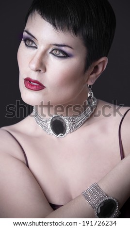 Sexy woman with elegant silver jewelry looking interesting