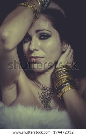 Style brunette woman with gold and silver jewelry