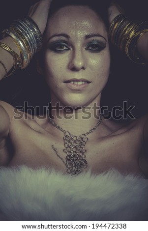 Beauty brunette woman with gold and silver jewelry