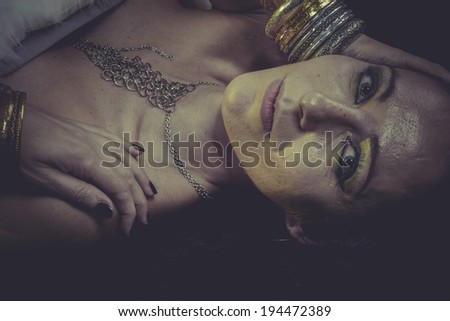 Elegance brunette woman with gold and silver jewelry