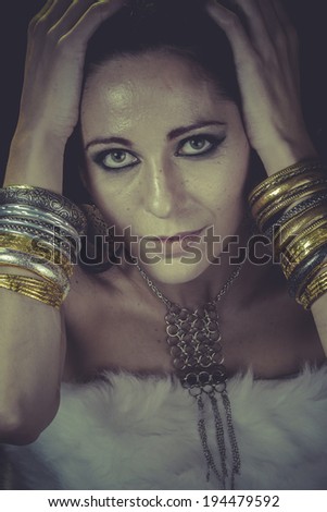 Sexy brunette woman with gold and silver jewelry
