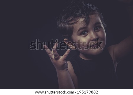 little boy with slicked-back hair, funny and expressive