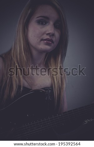 Sound, Beautiful blonde with black electric guitar