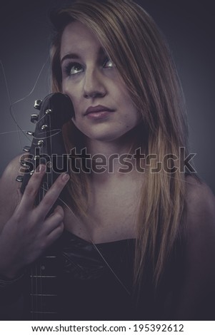 Pretty Beautiful blonde with black electric guitar