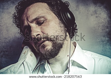 Joy, listening and enjoying music with headphones, man in white shirt with funny expressions