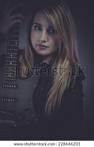 Star Pretty and beautiful blonde with black electric guitar